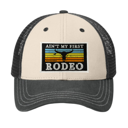 Trucker hat with 'Ain't My First Rodeo' text and graphic on a white background